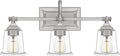 Quoizel Nicholas Vanity Lights, 22 Inch 3-Light Brushed Nickel Bathroom Lighting Fixtures Over Mirror, 100W, Clear Glass, Mid-Century Wall Mount Light for Bathrooms, Kitchen or Hallway