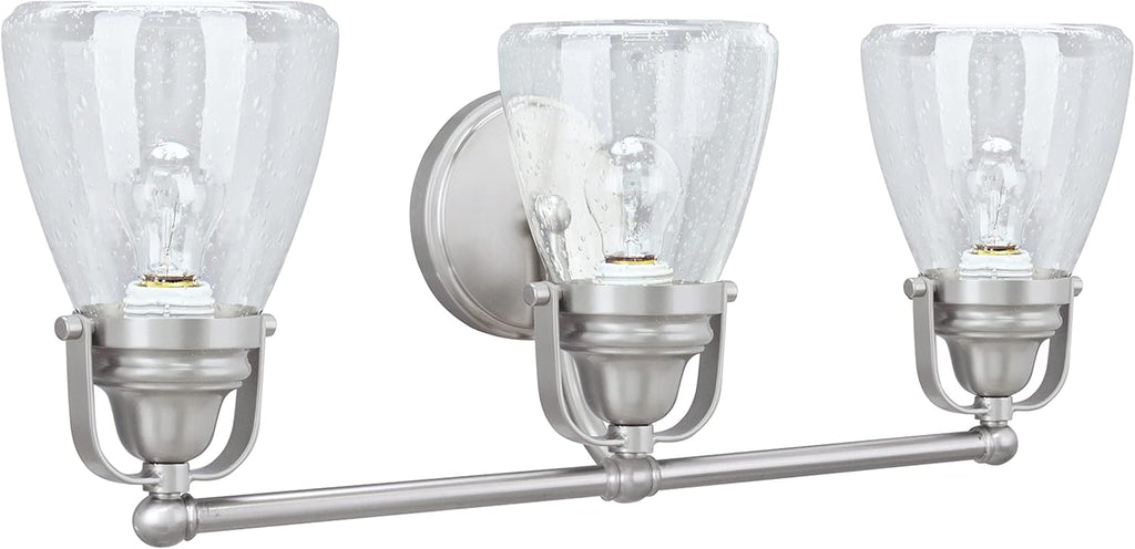 Aspen Creative 62099, Three-Light Metal Bathroom Vanity Wall Light Fixture, 24 1/2' Wide, Transitional Design in Brushed Nickel with Clear Seedy Glass Shade