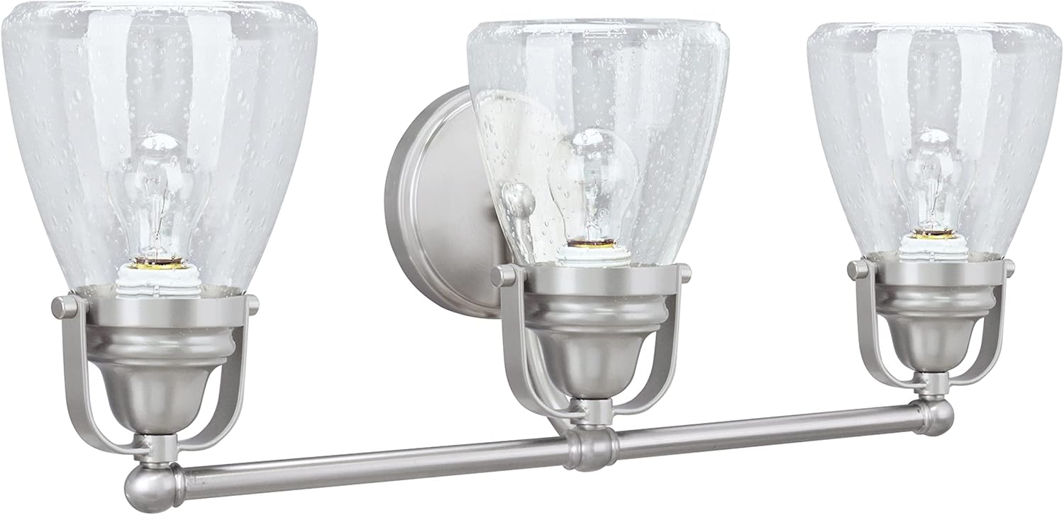Aspen Creative 62099, Three-Light Metal Bathroom Vanity Wall Light Fixture, 24 1/2' Wide, Transitional Design in Brushed Nickel with Clear Seedy Glass Shade