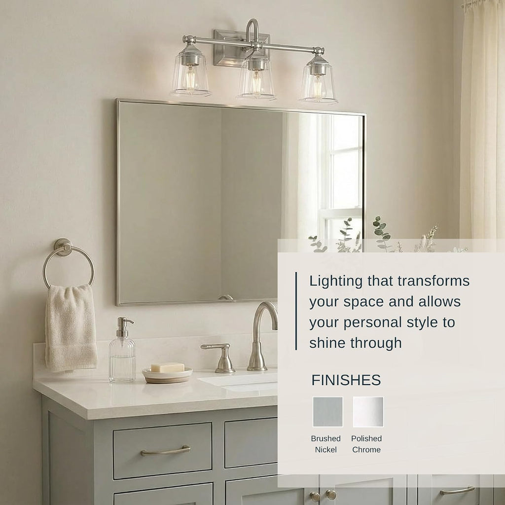 Quoizel Nicholas Vanity Lights, 22 Inch 3-Light Brushed Nickel Bathroom Lighting Fixtures Over Mirror, 100W, Clear Glass, Mid-Century Wall Mount Light for Bathrooms, Kitchen or Hallway